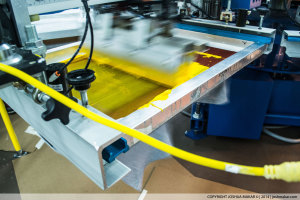 A yellow color stop on a screen-printing press.
