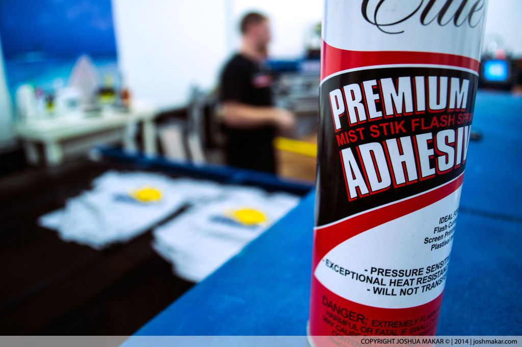 Close-up of a can of Premium Adhesive used for screen-printing.